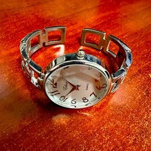Silver color Cuff style watch.